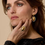 Statement earrings with an oval charm surrounded by stones