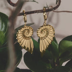 Small hoop earrings with large twist shell charm