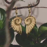 Small hoop earrings with large twist shell charm