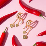 Triple earrings with heart pendants and pearl