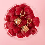 Earrings with dangling hearts and sunbeams