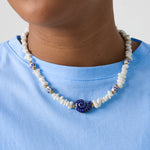 Necklace with stone beads, white beads with blue flowers and statement shell