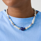 Necklace with stone beads, white beads with blue flowers and statement shell