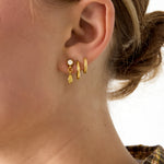 Stud earrings with dangling drop