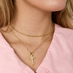 Necklace with decorated cross pendant and charms