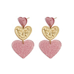 Statement earrings with glitter hearts