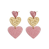 Statement earrings with glitter hearts