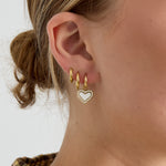 Earrings with dangling mother-of-pearl hearts