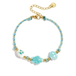 Bracelet with tortoise and shell beads and rope motif