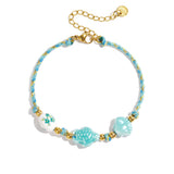Bracelet with tortoise and shell beads and rope motif