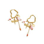 Heart-shaped hoop earrings with beaded pendants and charms