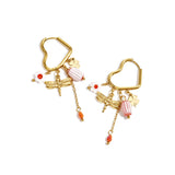 Heart-shaped hoop earrings with beaded pendants and charms