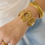 Cuff statement bracelet with spiral shells