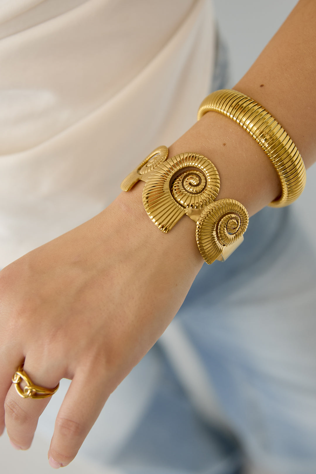 Cuff statement bracelet with spiral shells