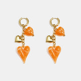 Earrings with dangling hearts on a chain