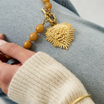 Bead necklace with front closure charm