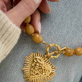 Bead necklace with front closure charm