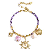 Colorful cord bracelet with varying pendants purple