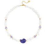 Necklace with stone beads, white beads with blue flowers and statement shell