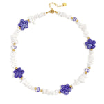 Necklace with stone beads, white beads with blue flowers and statement flowers