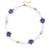 Necklace with stone beads, white beads with blue flowers and statement flowers