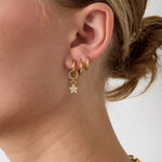Small earring with dangling embellished star