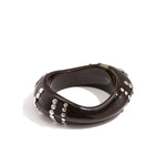 Resin bangle bracelet with studs in a striped pattern