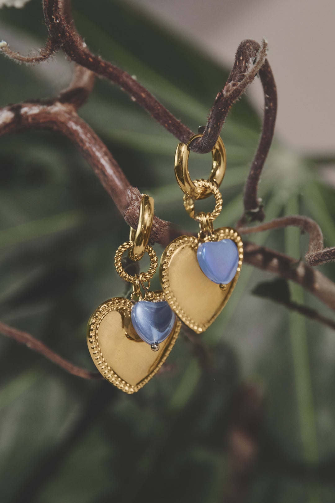 Hoop earrings with heart pendant and bead on ring