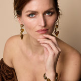 Earrings with dangling hearts on a chain
