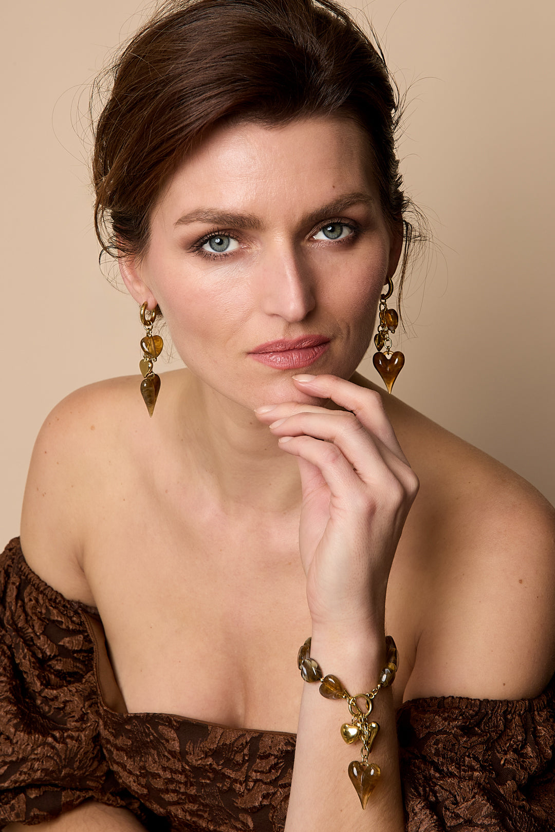 Earrings with dangling hearts on a chain