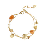 Charm bracelet with orange beads, flowers and hearts
