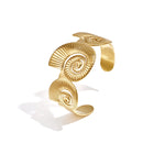 Cuff statement bracelet with spiral shells