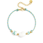 Rope bracelet with shell and floral design beads