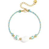 Rope bracelet with shell and floral design beads