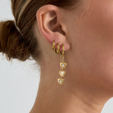 Earrings with dangling hearts at different heights