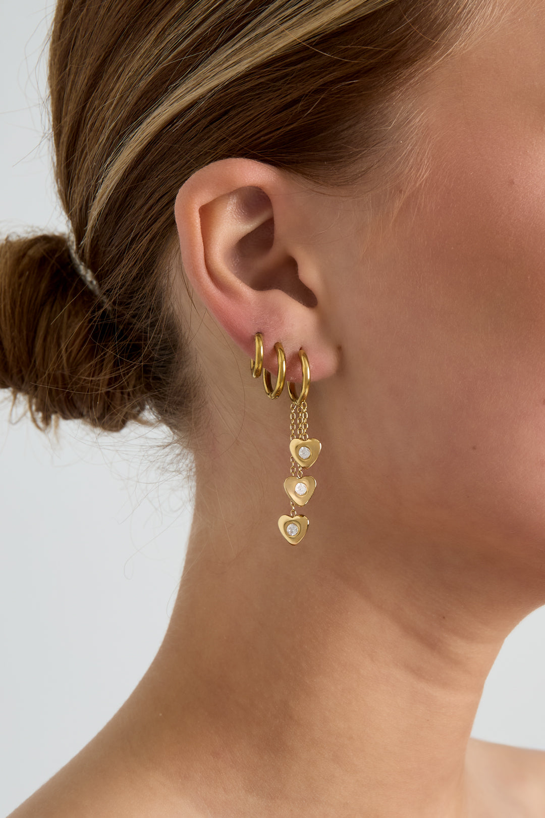 Earrings with dangling hearts at different heights