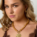 Bead necklace with front closure charm