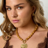 Bead necklace with front closure charm