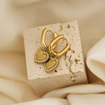 Squoval earrings with heart charms with set edges