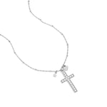 Necklace with decorated cross pendant and charms