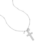 Necklace with decorated cross pendant and charms