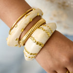 Resin bangle bracelet with studs in a striped pattern