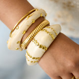 Resin bangle bracelet with studs in a striped pattern