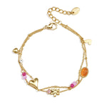 Double bracelet with varying pendants, beads, and stones