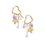 Heart-shaped hoop earrings with beaded pendants and charms
