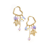 Heart-shaped hoop earrings with beaded pendants and charms