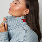 Round earrings with hanging flower