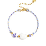 Rope bracelet with shell and floral design beads