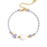 Rope bracelet with shell and floral design beads