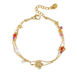 Charm bracelet with star and flower charms, pearls, stones and beads